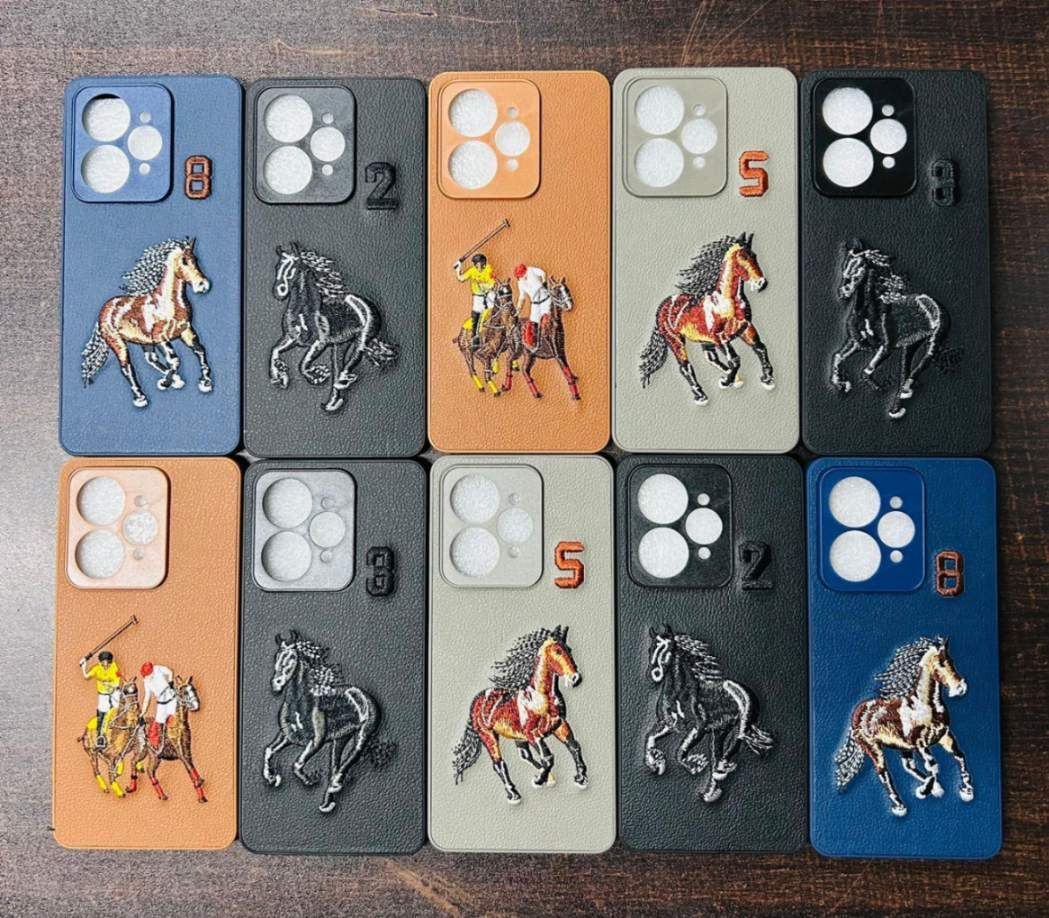 Designer embroidered leather mobile covers laid out in a wholesale display tray